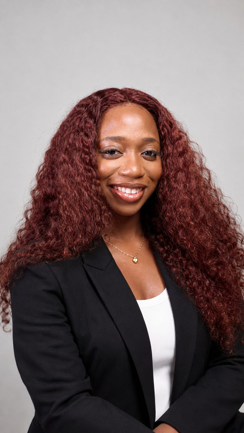 Success Wokili smiling in a black blazer